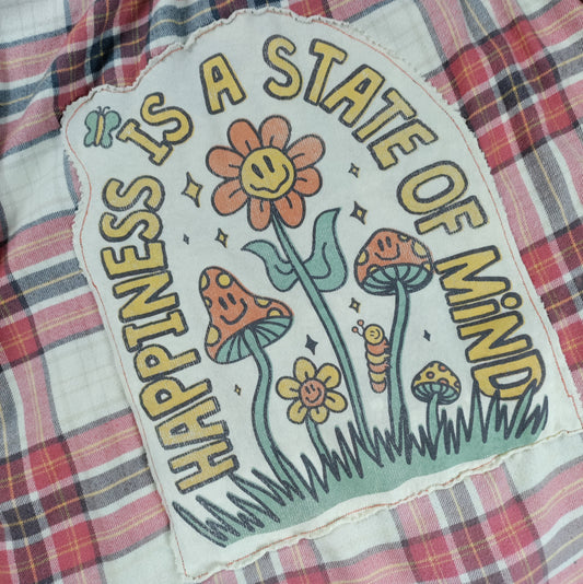 Floral patch with 'Happiness is a State of Mind' text on plaid fabric