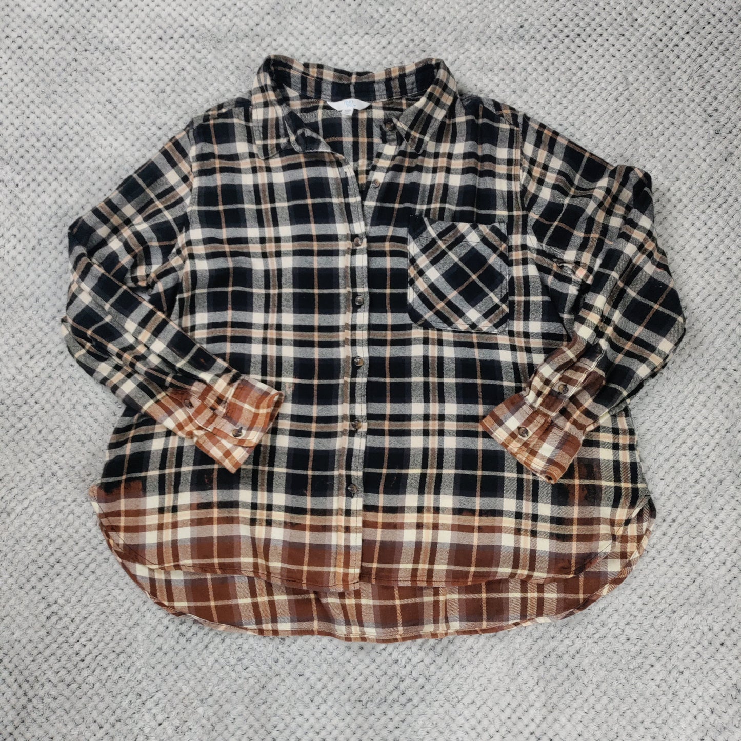Plaid shirt on a textured gray surface