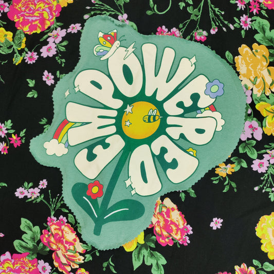 Floral pattern with 'EMPOWERED' text on a black background