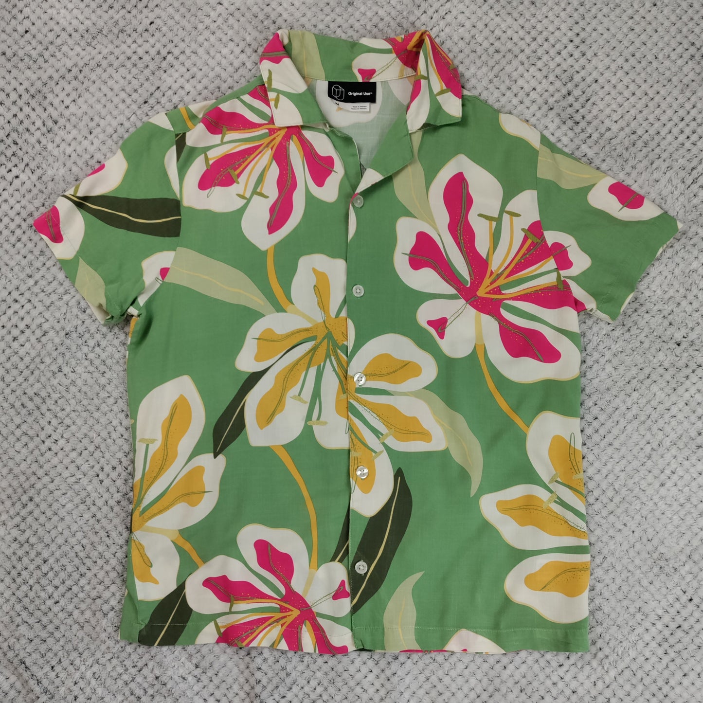 Floral patterned shirt on a textured gray background