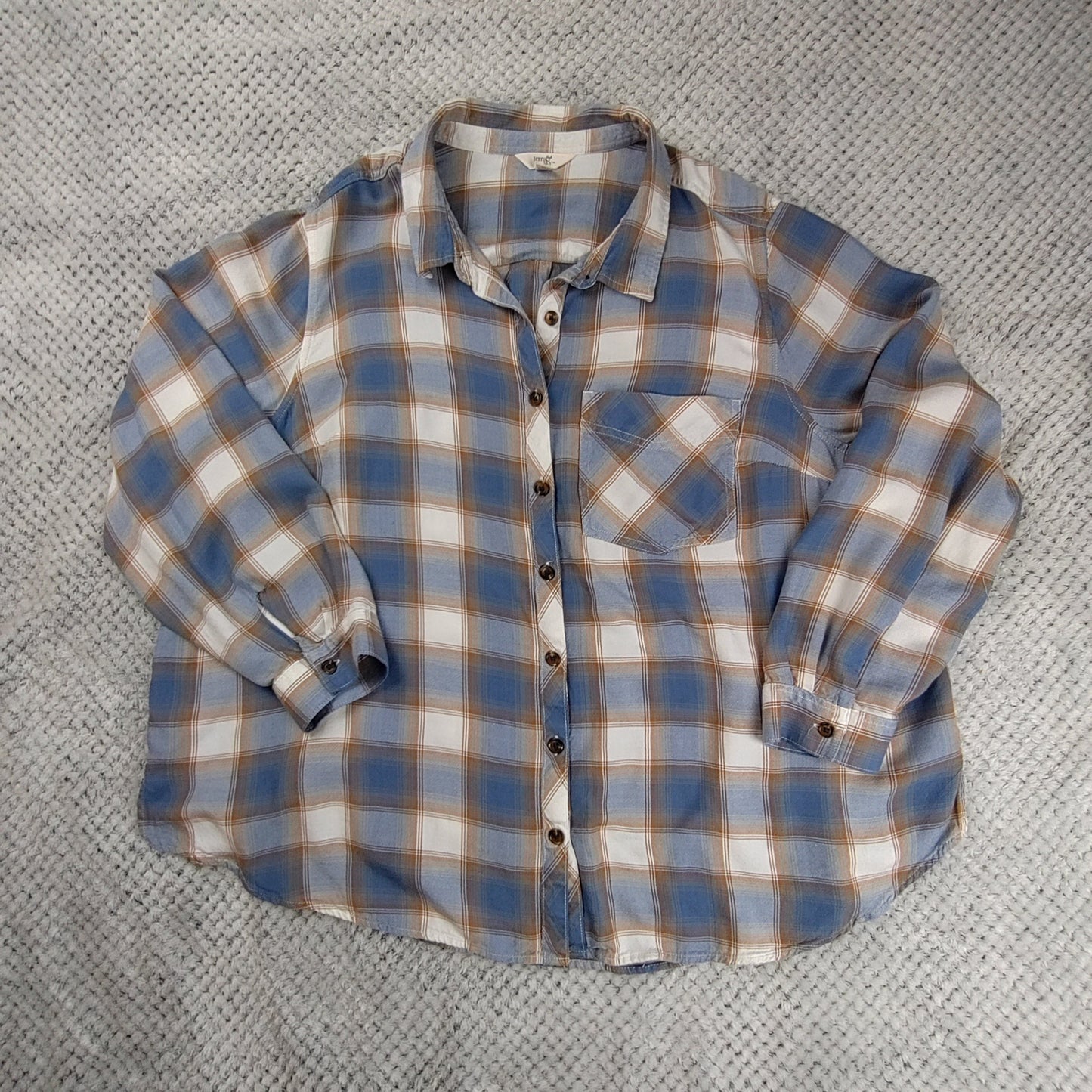 Plaid shirt on a textured gray surface