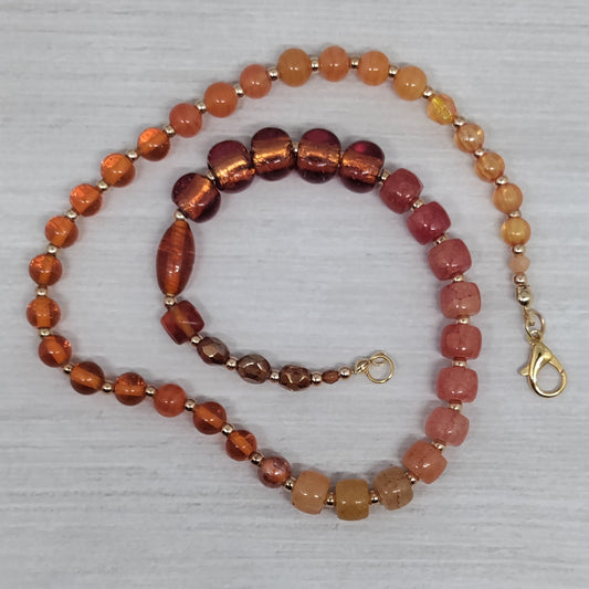 Beaded necklace and bracelet set on a textured surface