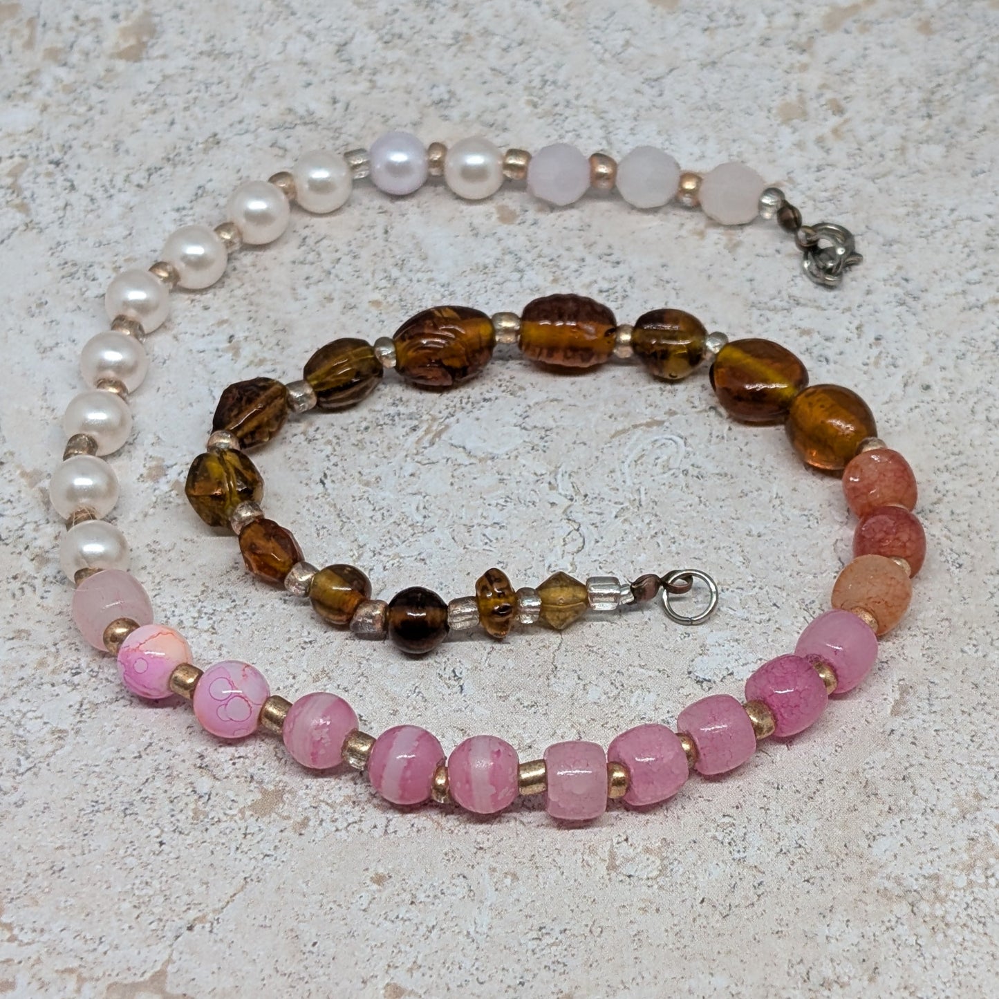 Set of beaded bracelets on a textured surface