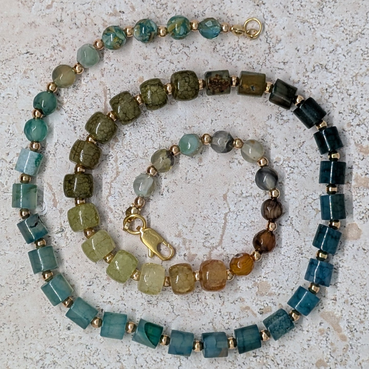 Multicolored beaded necklace on a textured surface