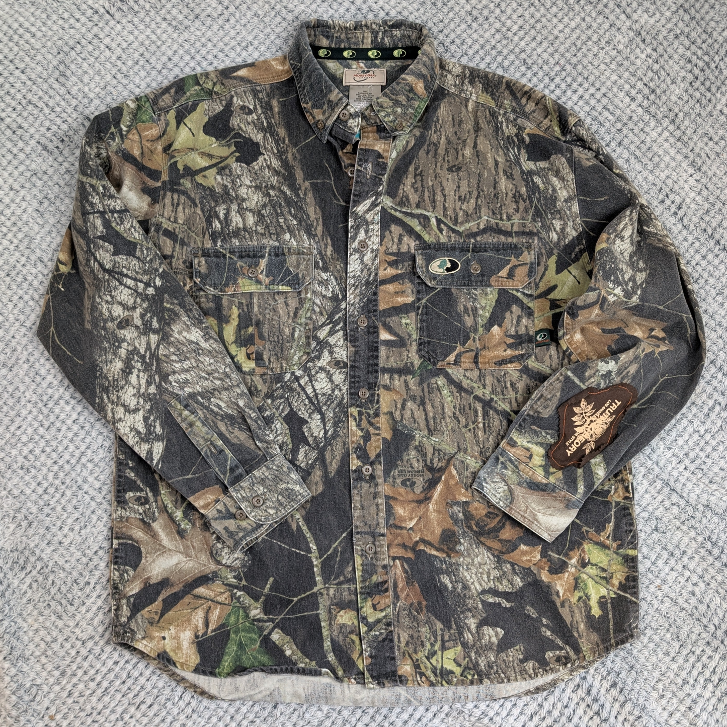 Camouflage jacket on a textured gray surface