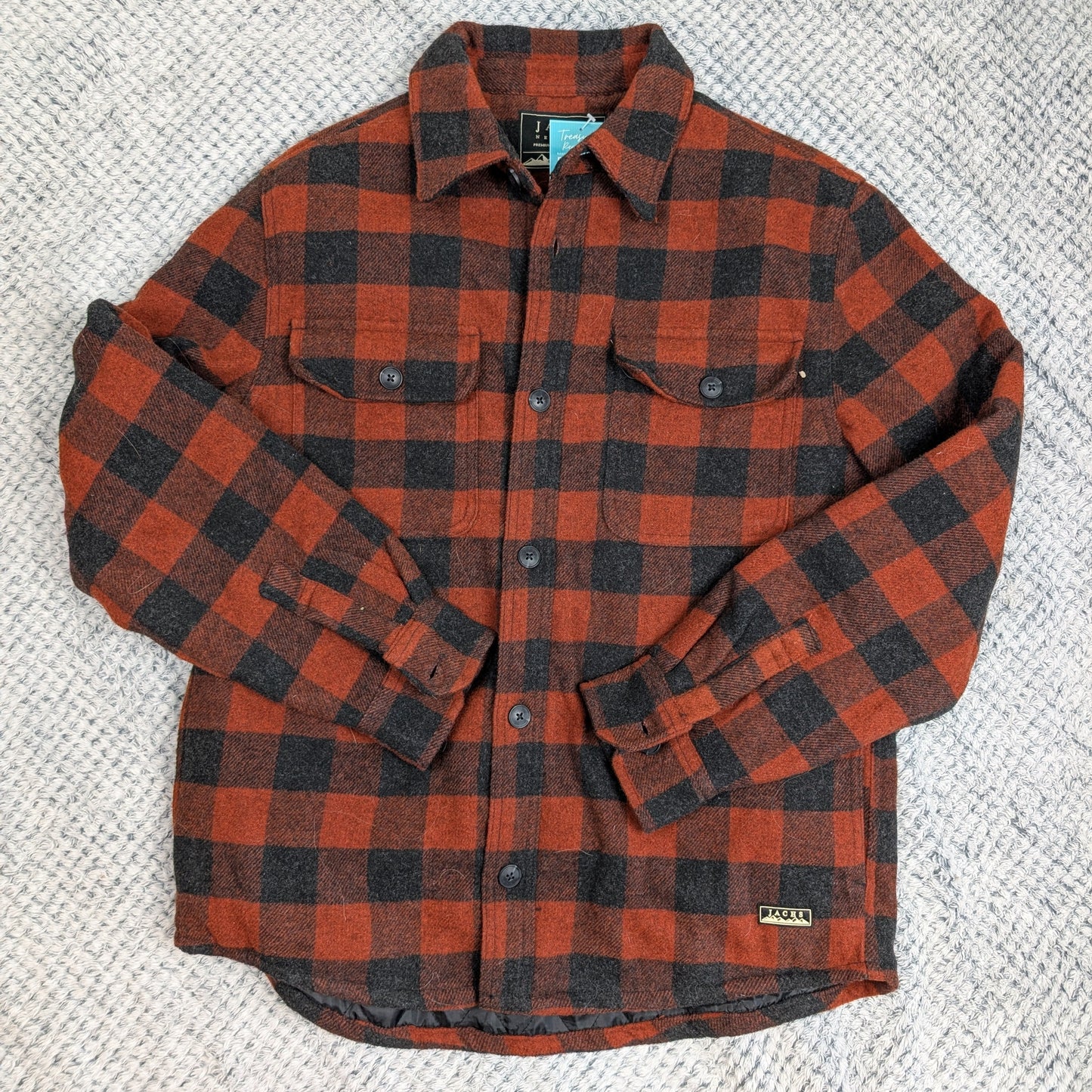 Red and black plaid shirt on a textured gray background