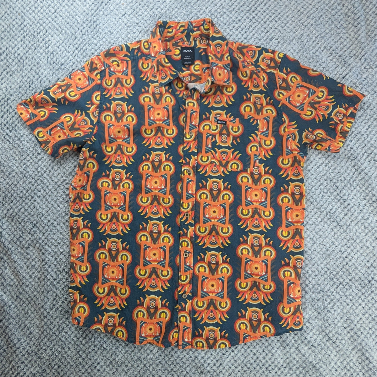 Short Sleeve button up shirt with bright orange graphic patterns.
