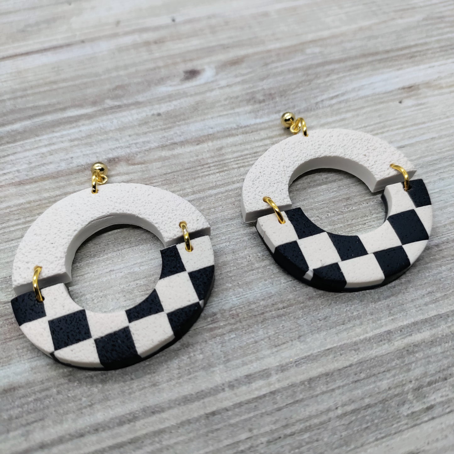 Pair of earrings with checkered design.
