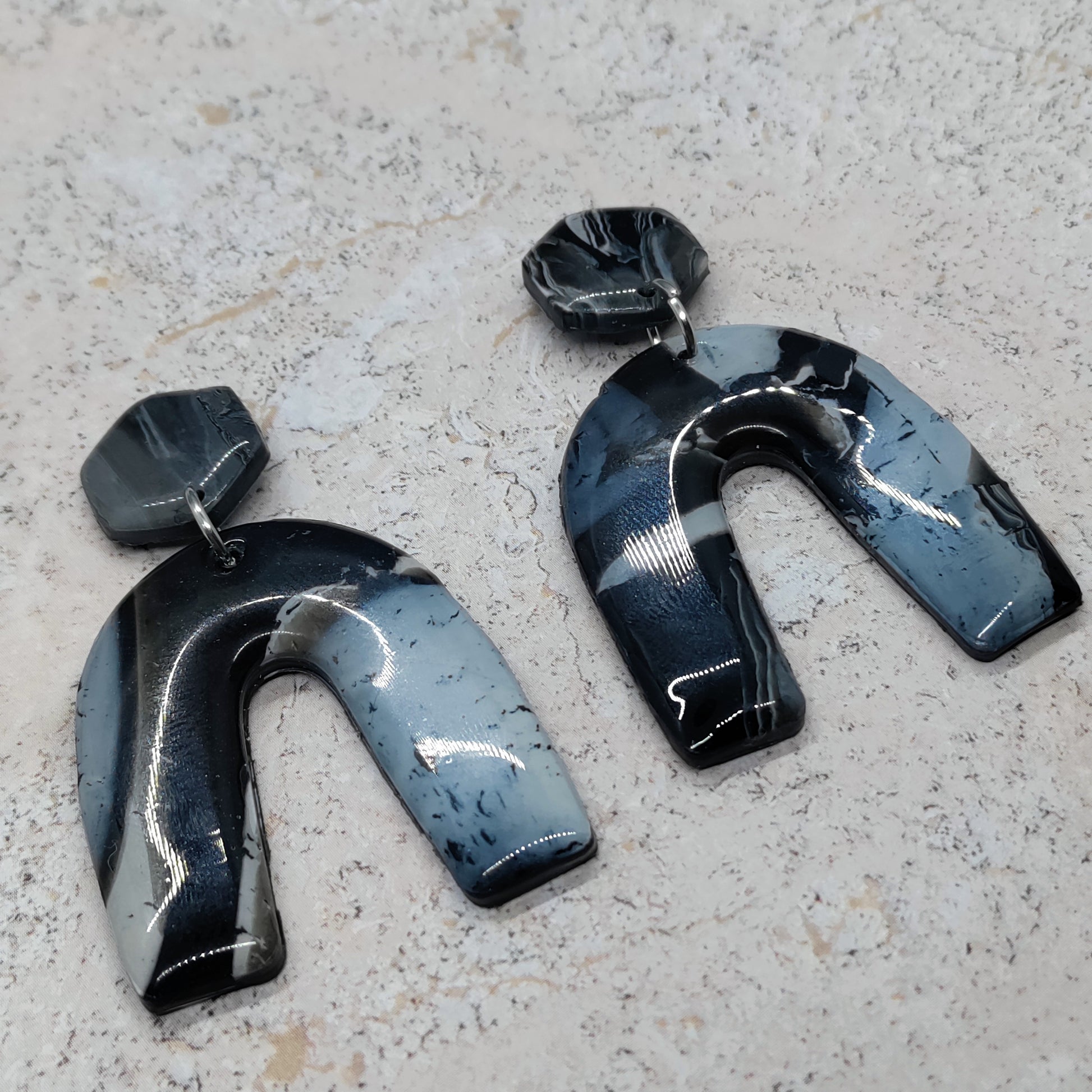 Pair of black and blue abstract earrings 