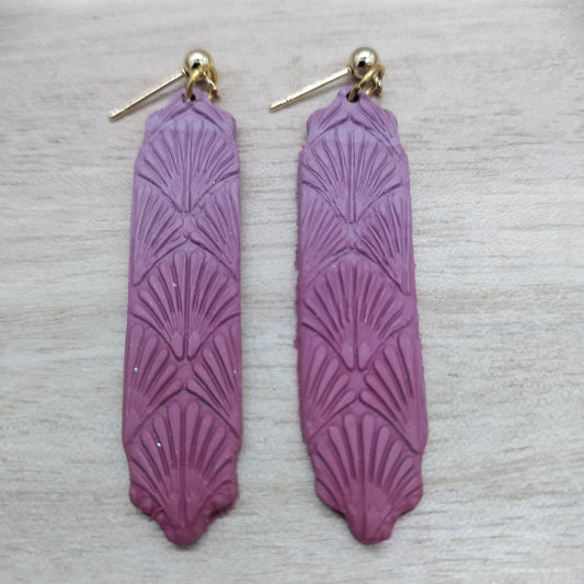 Purple earrings with gold hooks on a light gray background