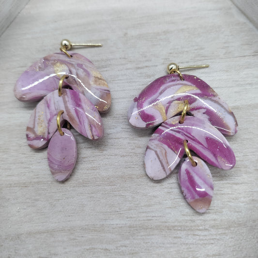 Pair of pink marbled earrings on a light gray background