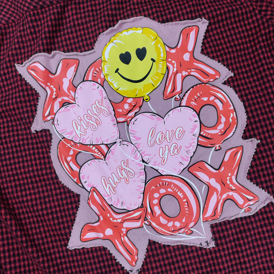 Decorative patch with smiley face, hearts, and 'XOXO' text on a red checkered fabric background