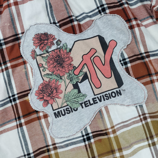 MTV Music Television patch on a plaid fabric background
