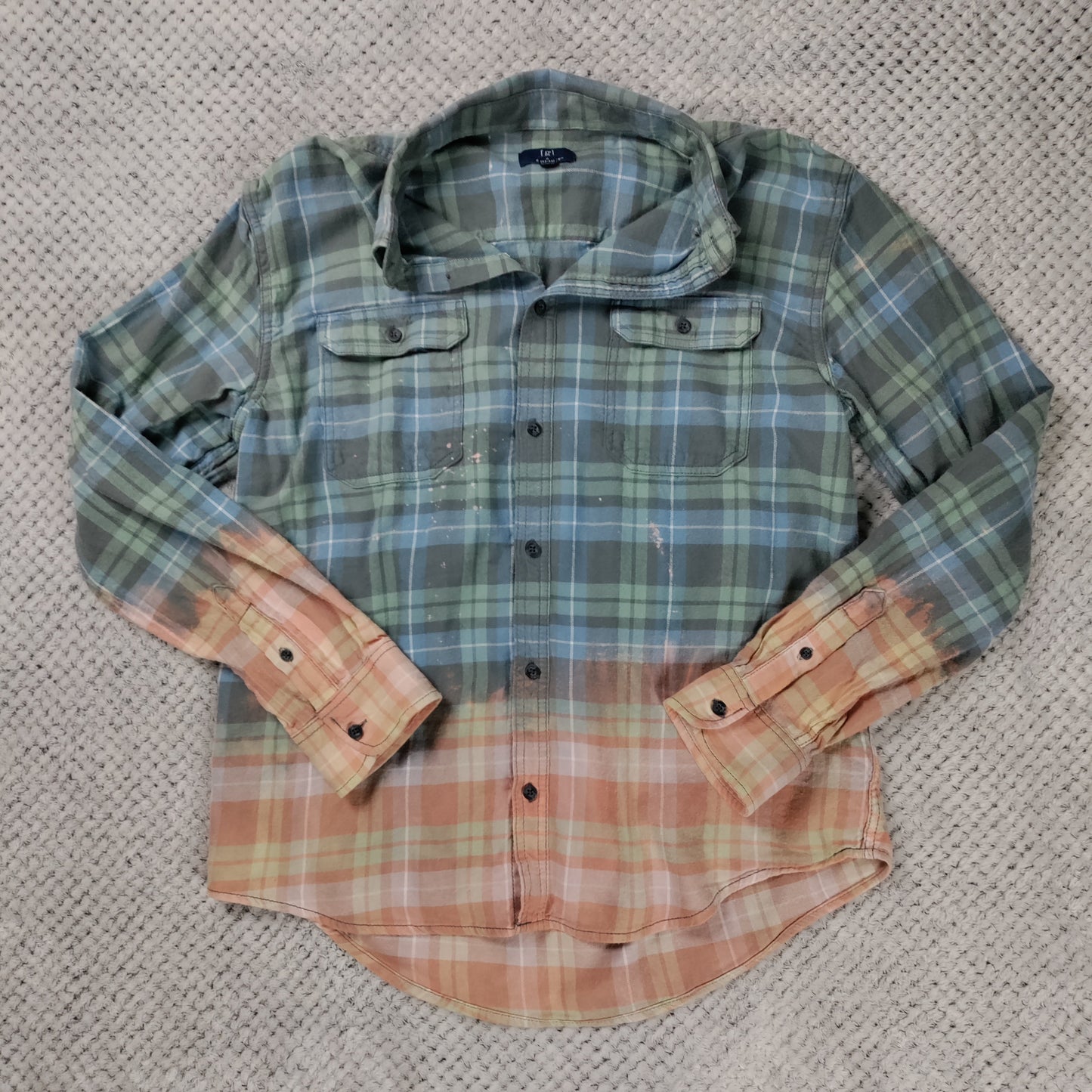 Plaid shirt with two different color patterns on a textured surface