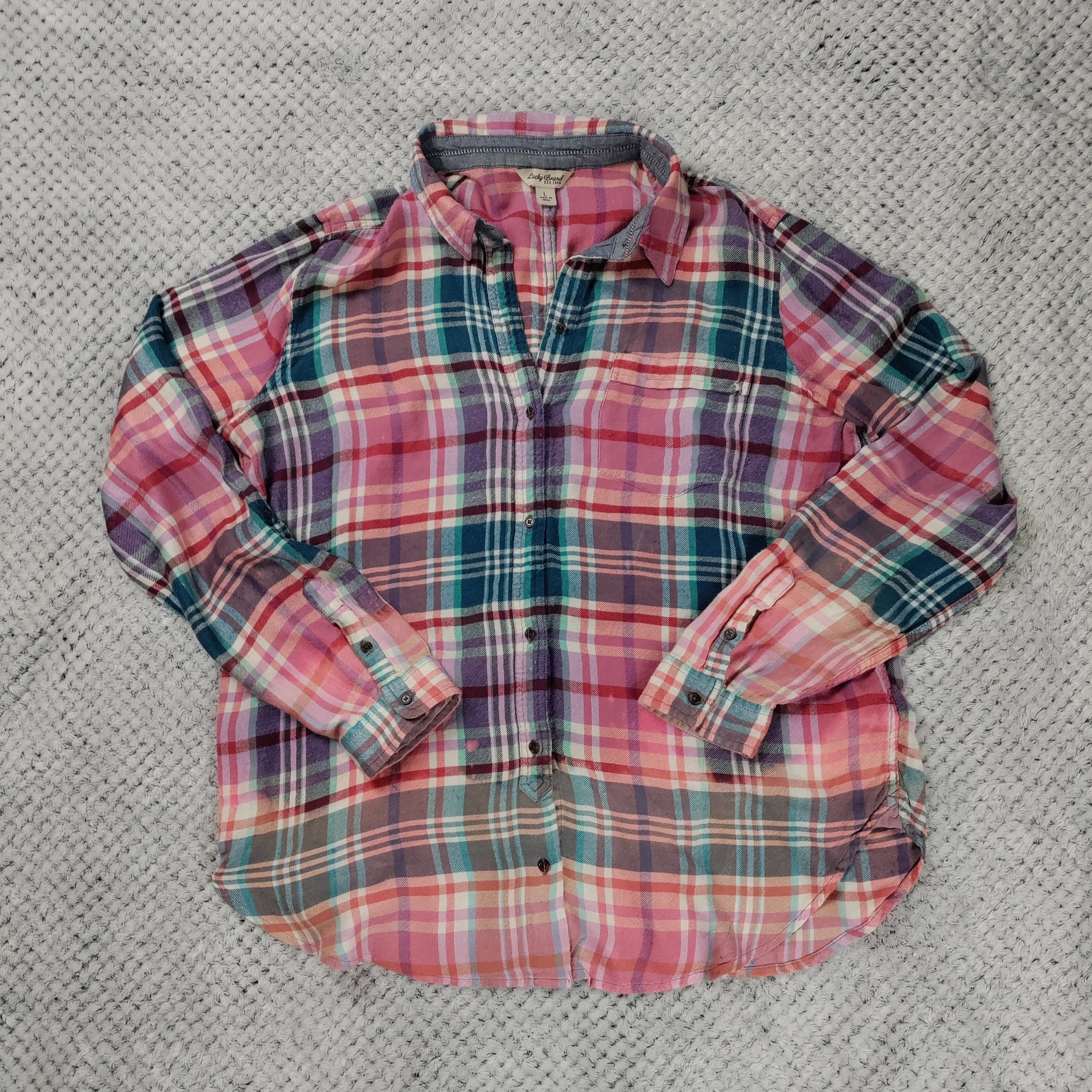 Plaid shirt on a textured gray surface