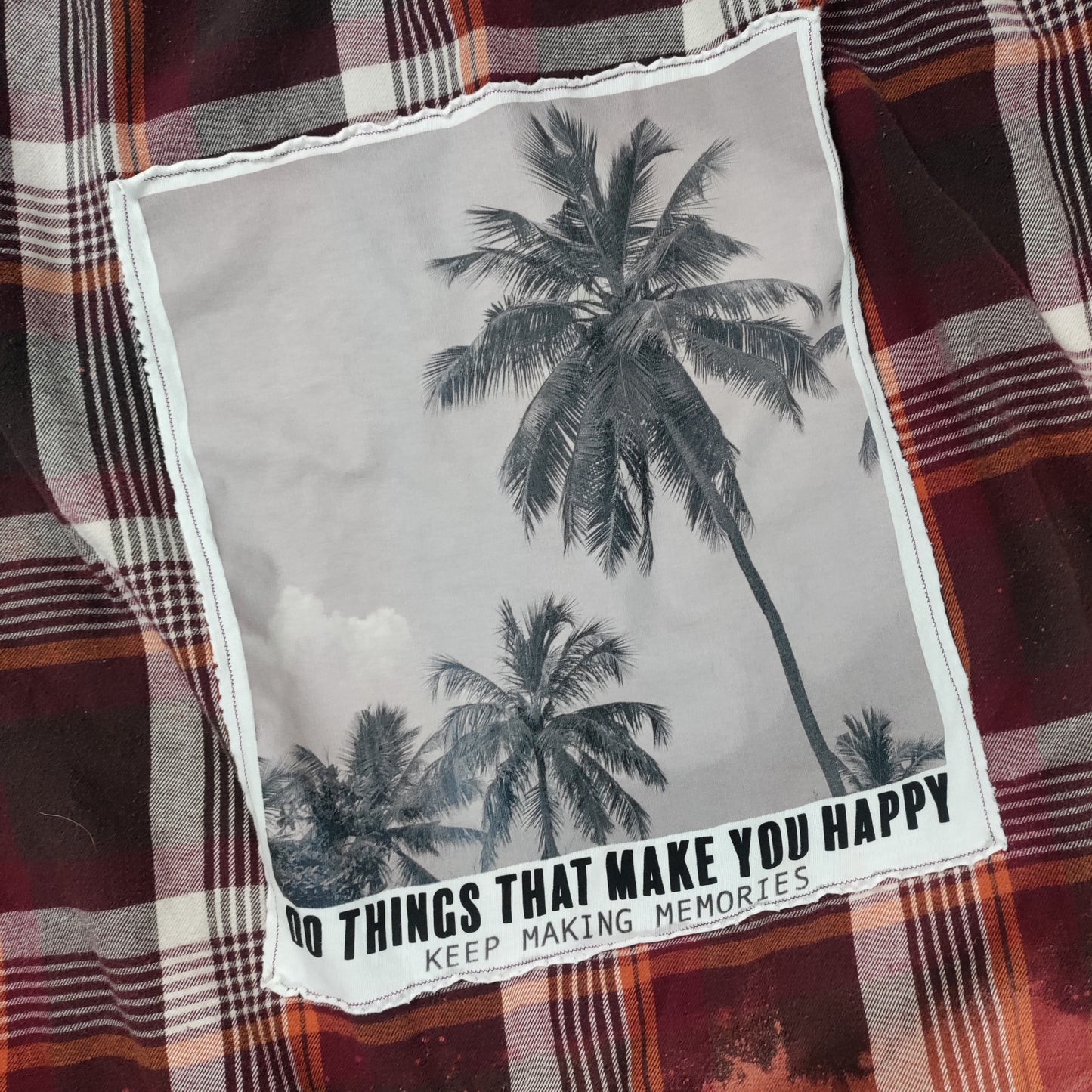 Plaid shirt with a palm tree graphic and text overlay on a gray background