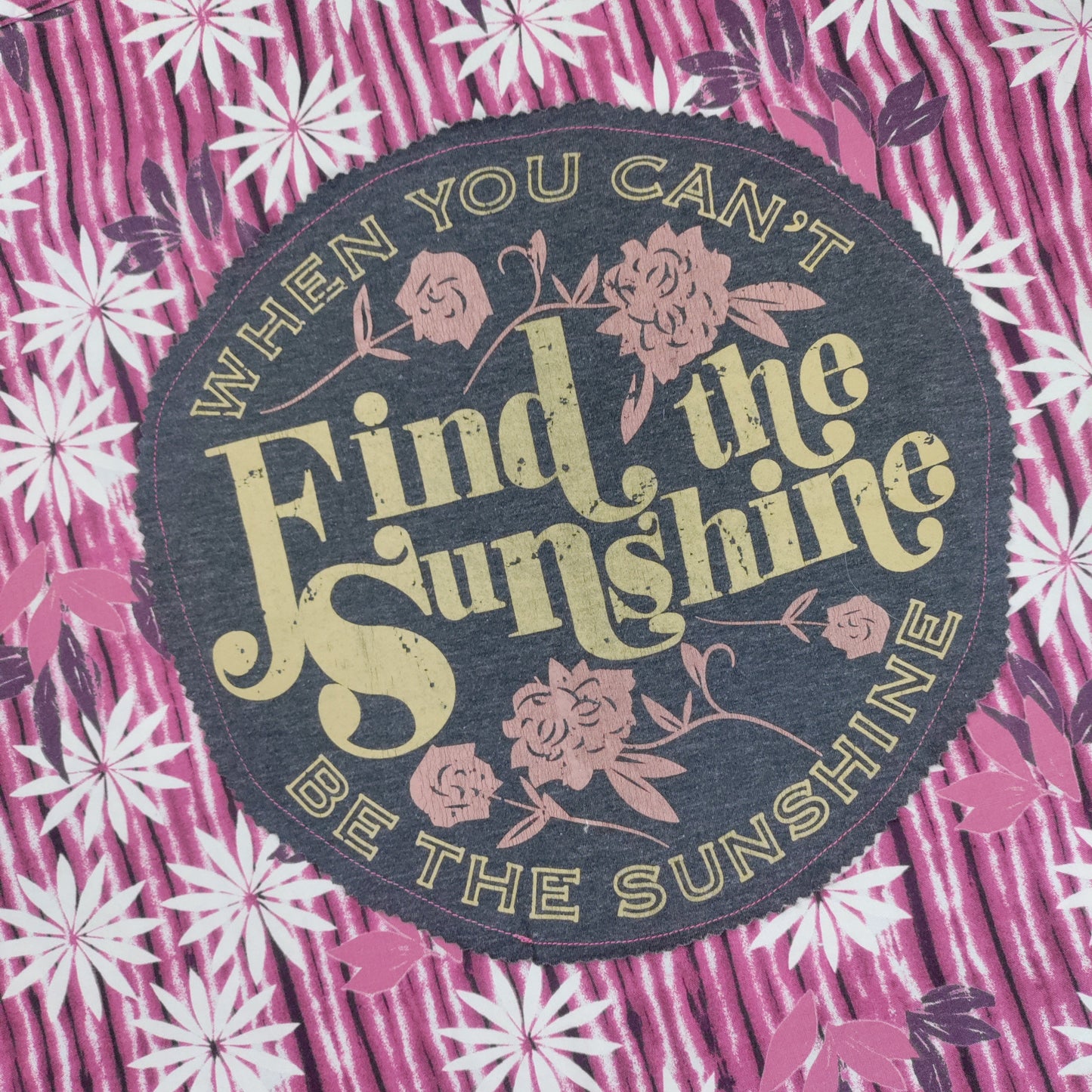 Floral patterned fabric with a motivational quote patch.