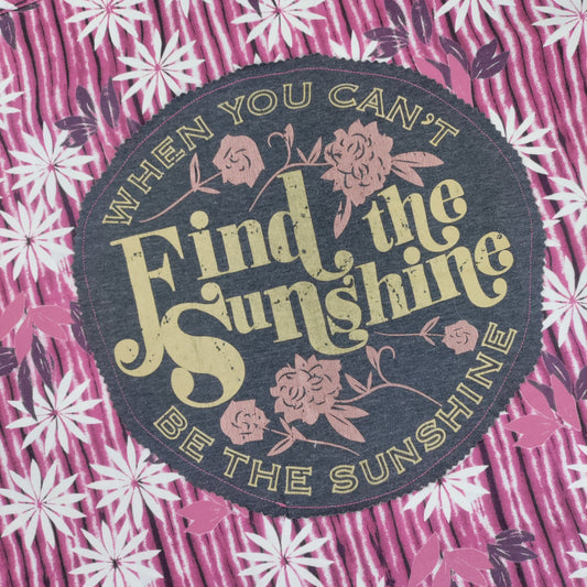 Floral patterned fabric with a motivational quote patch.