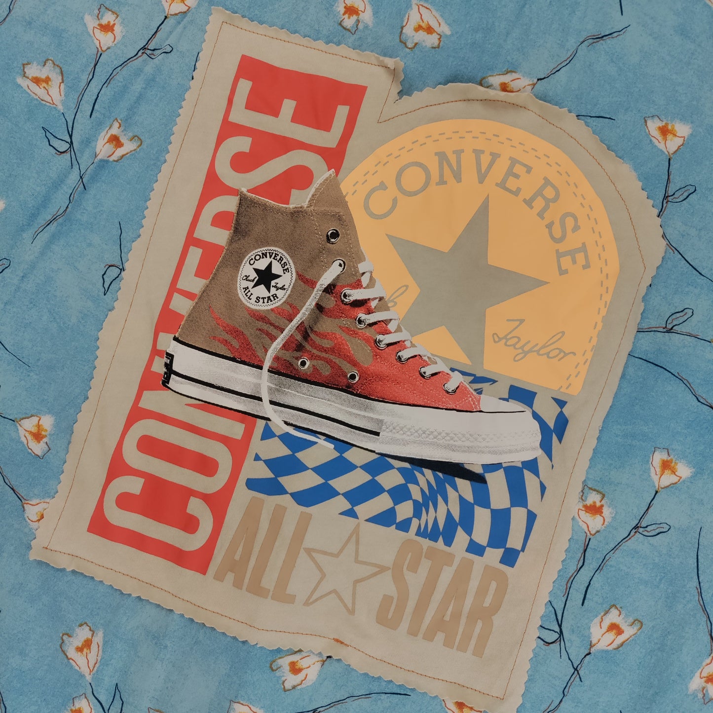 Converse All Star high-top sneaker with brand logos on a floral background