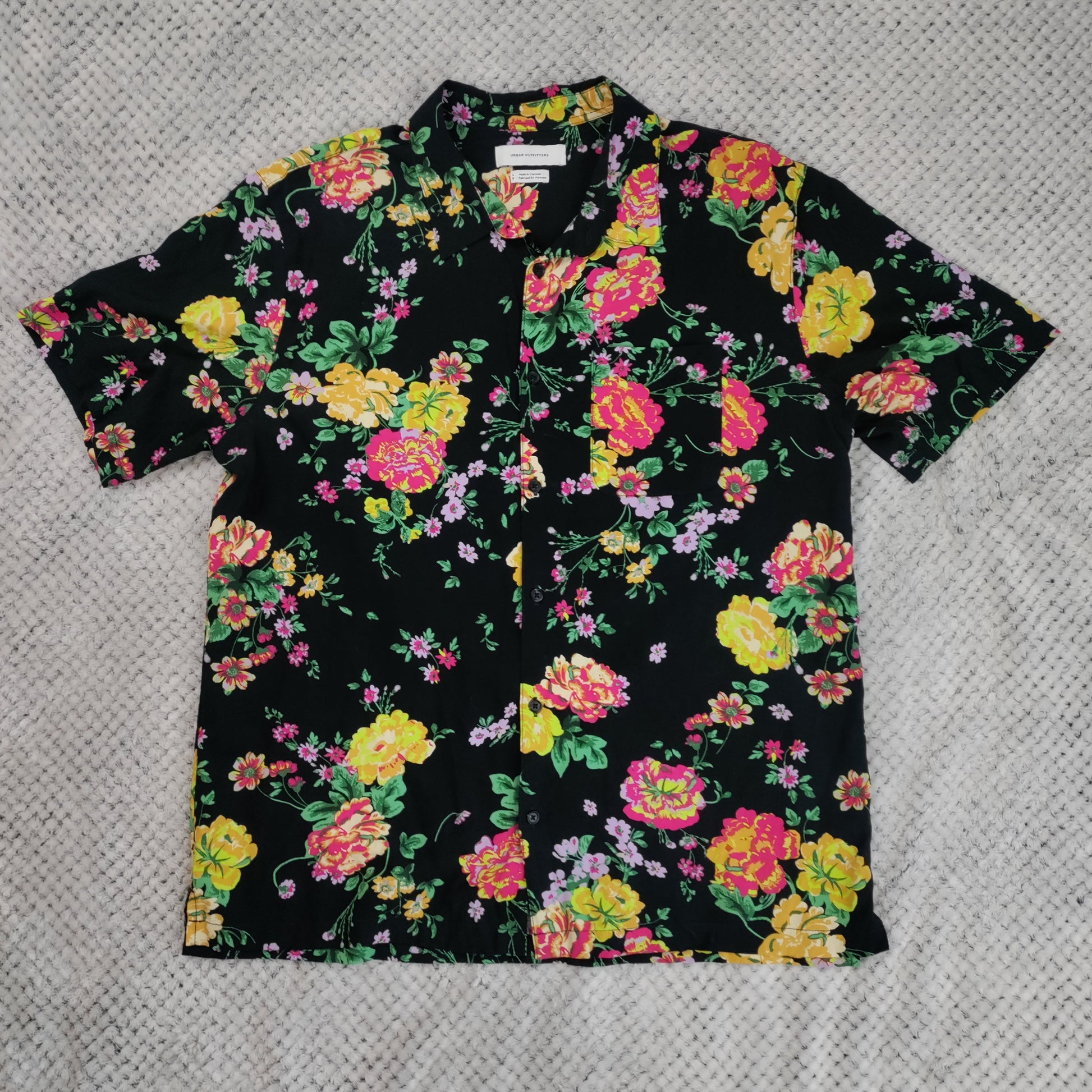Floral patterned shirt on a textured gray background