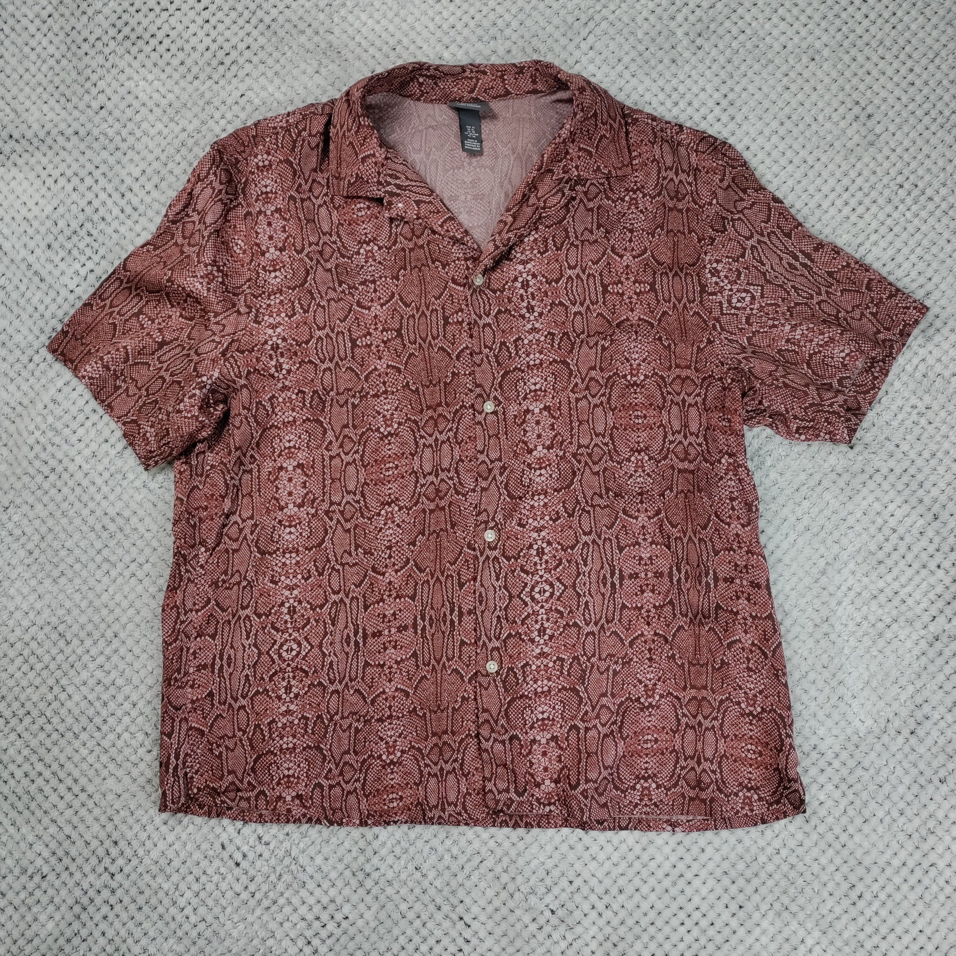 Brown patterned shirt on a textured gray background