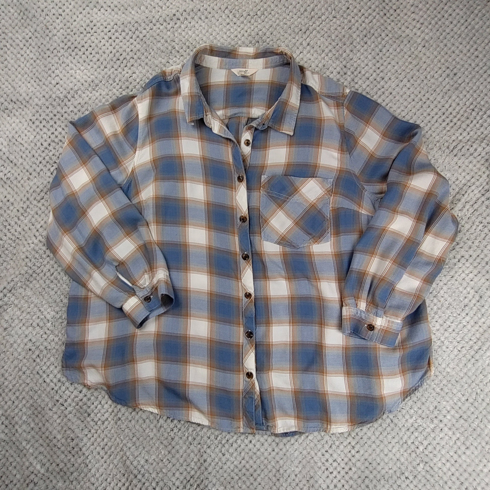 Plaid shirt on a textured gray surface