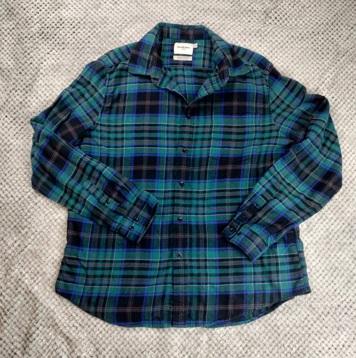 Plaid shirt on a textured gray surface