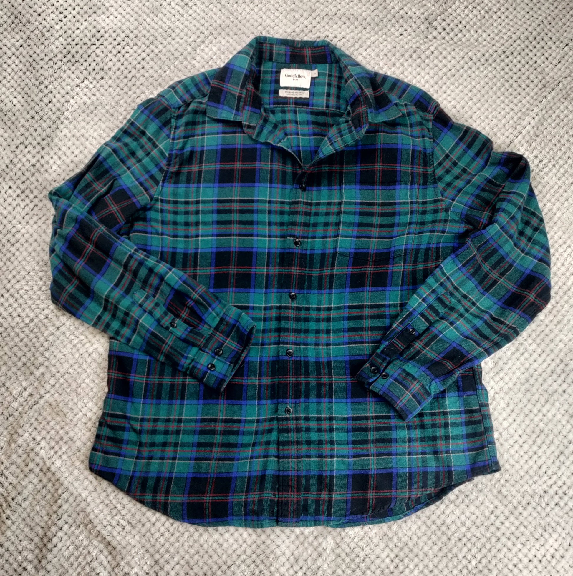 Plaid shirt on a textured gray surface