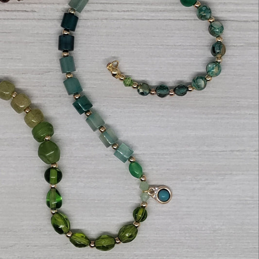 Necklace with multicolored beads on a textured white surface