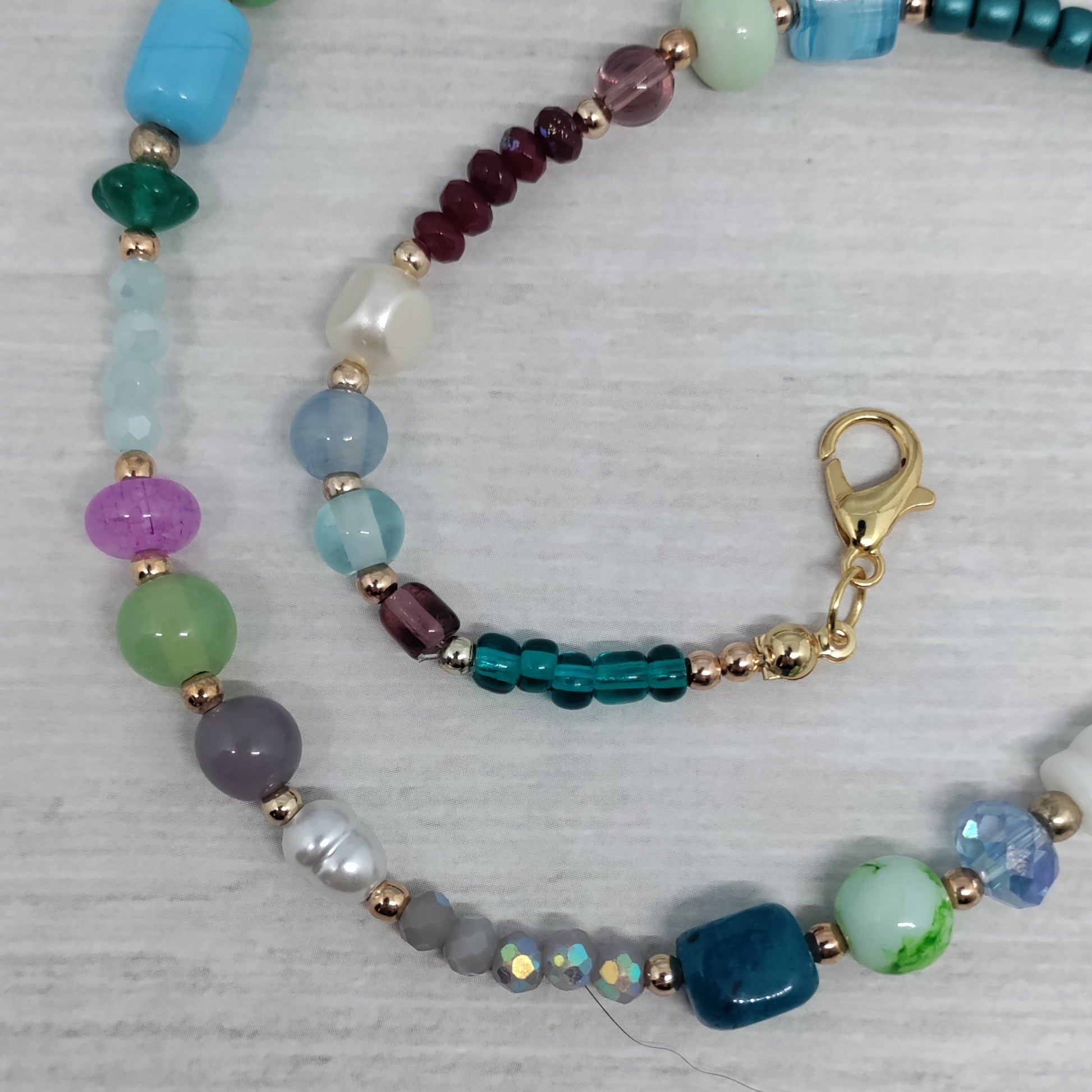 Multicolored beaded necklace on a light gray background