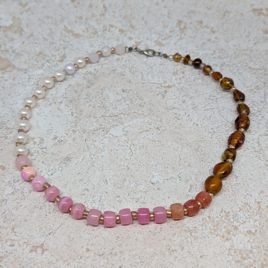 Necklace with multicolored beads on a light stone surface