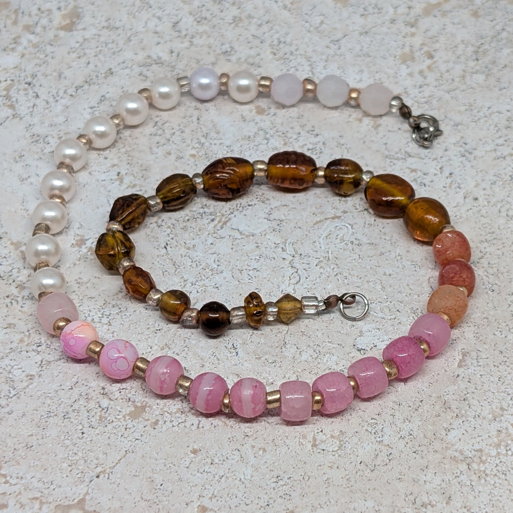 Set of beaded bracelets on a textured surface