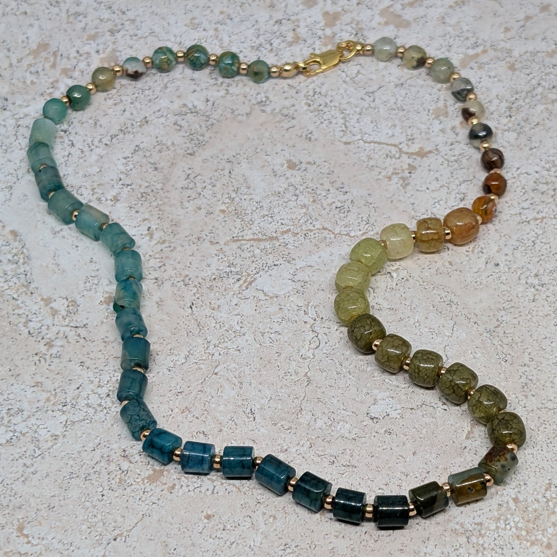 Necklace with multicolored beads on a textured surface