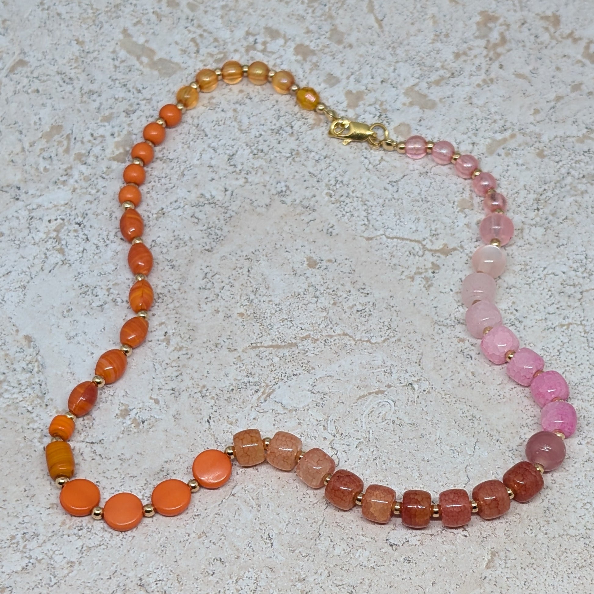 Necklace with multicolored beads on a textured surface