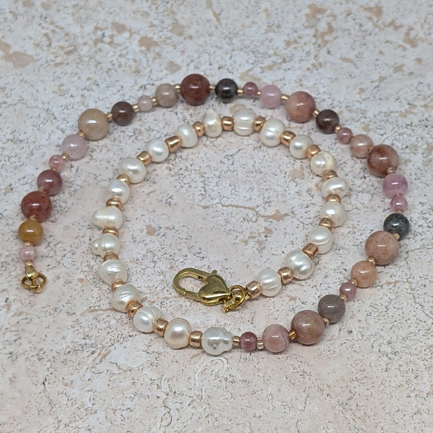 Beaded necklace with multicolored beads on a textured surface