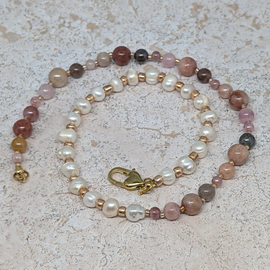 Beaded necklace with multicolored beads on a textured surface