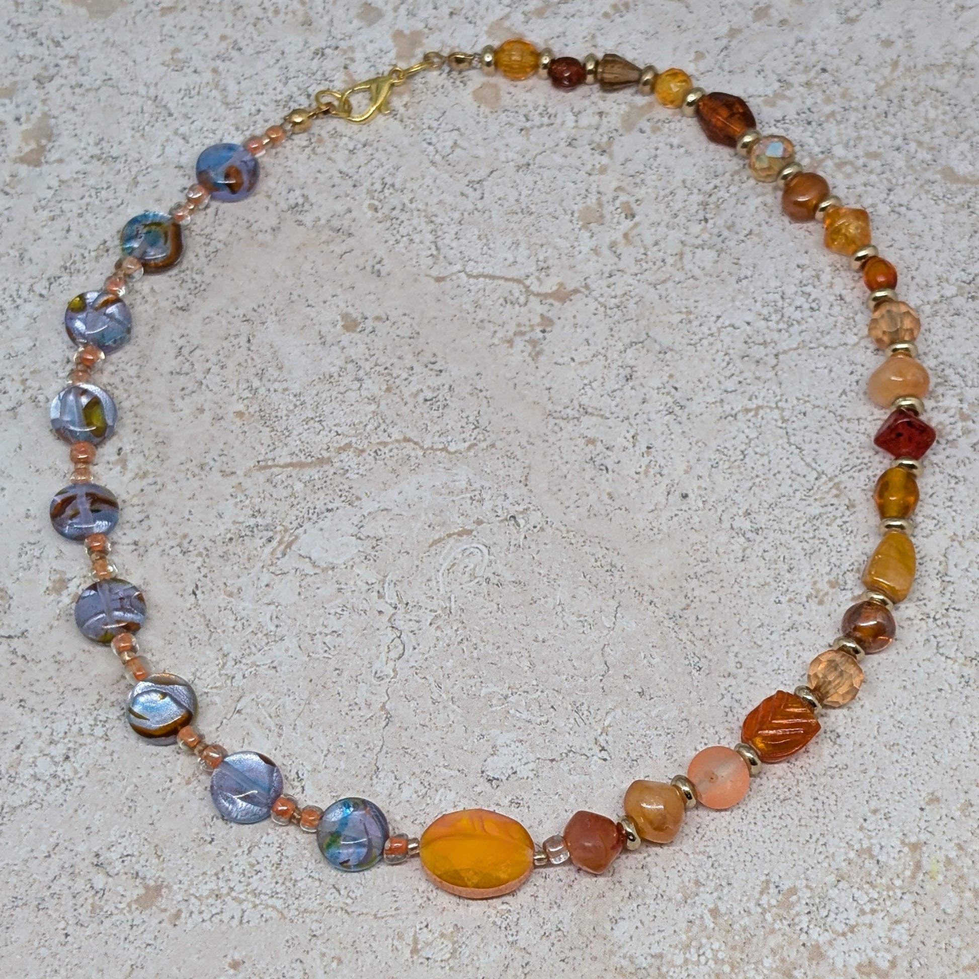 Necklace with multicolored beads on a textured surface