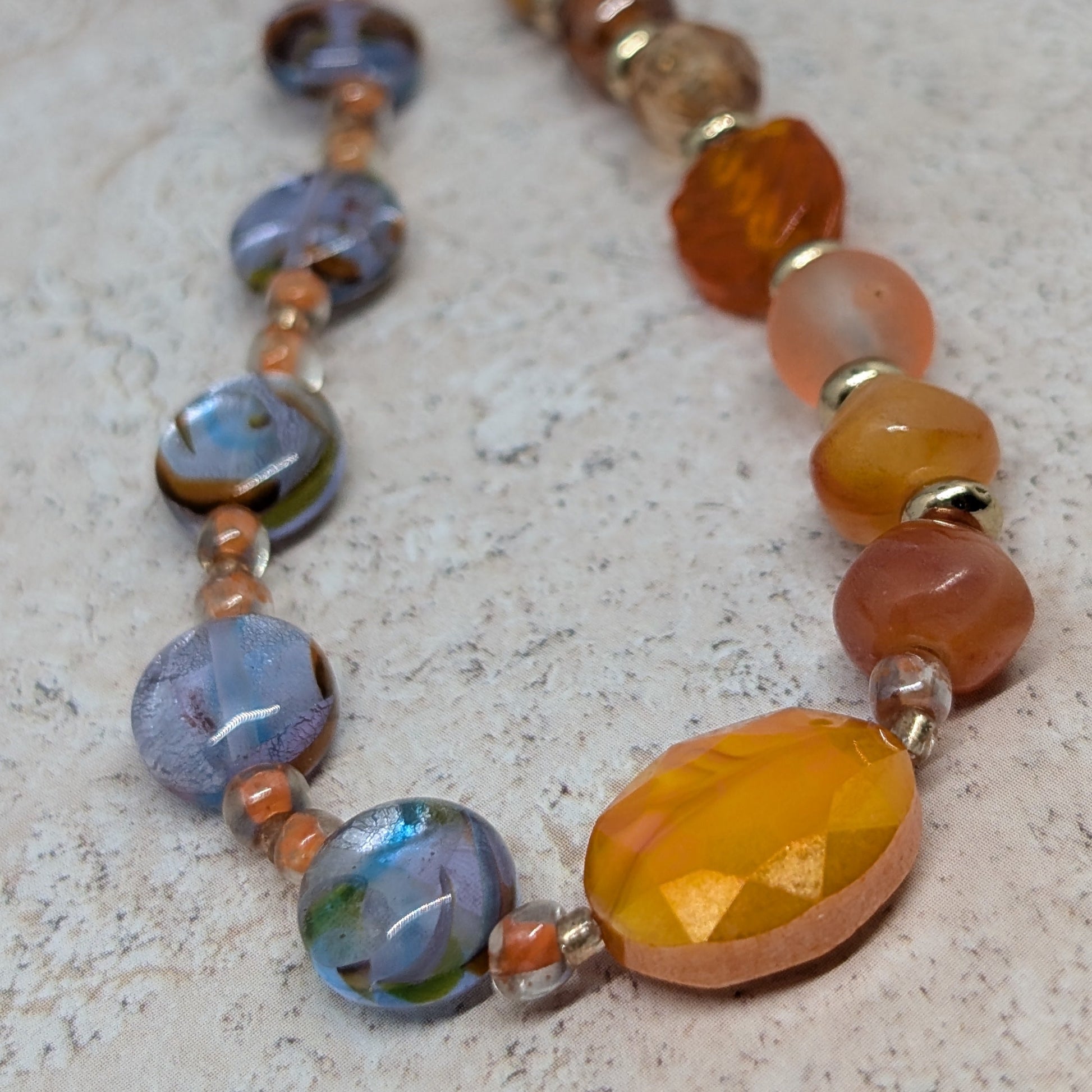 Necklace with multicolored beads on a textured surface
