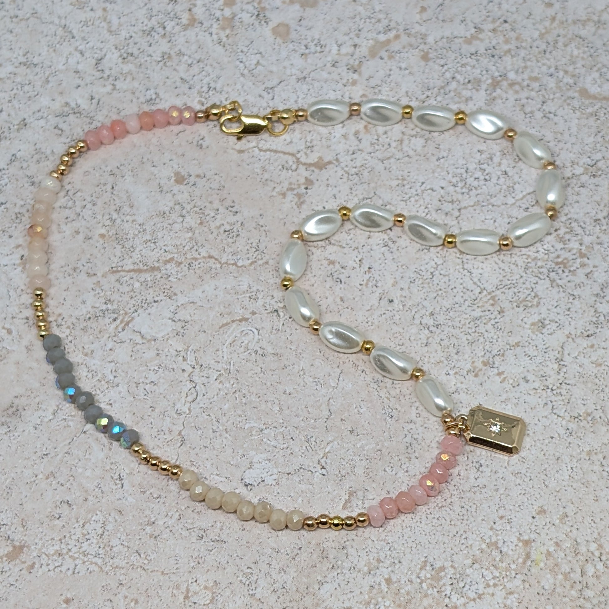 Beaded necklace with gold accents on a textured surface