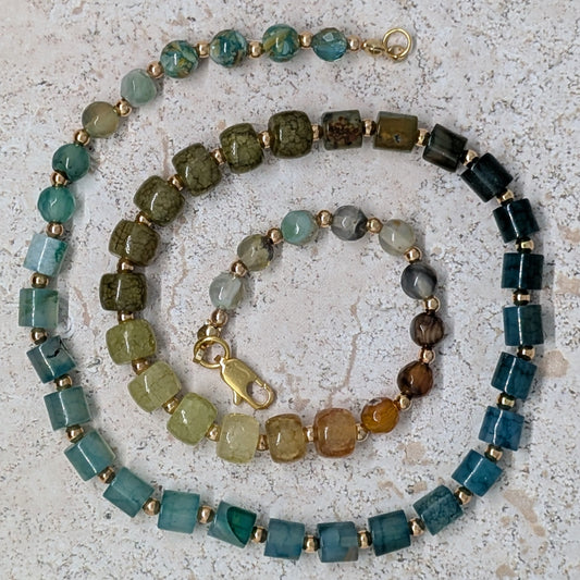 Multicolored beaded necklace on a textured surface