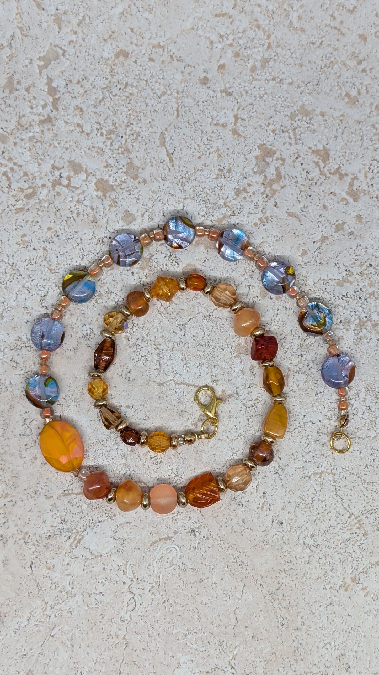 Necklace with multicolored beads on a textured surface
