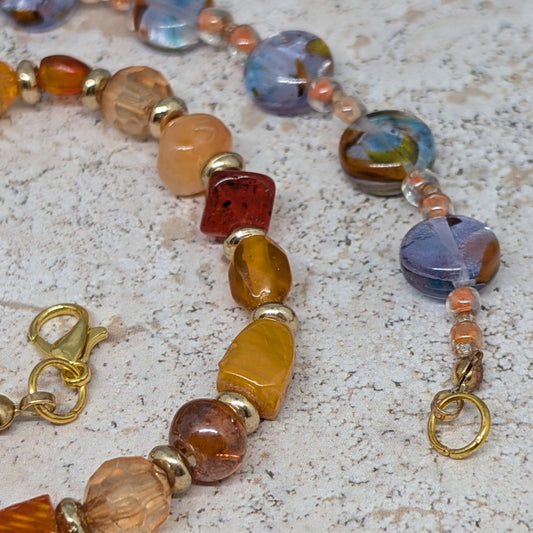 Colorful beaded necklace on a textured surface
