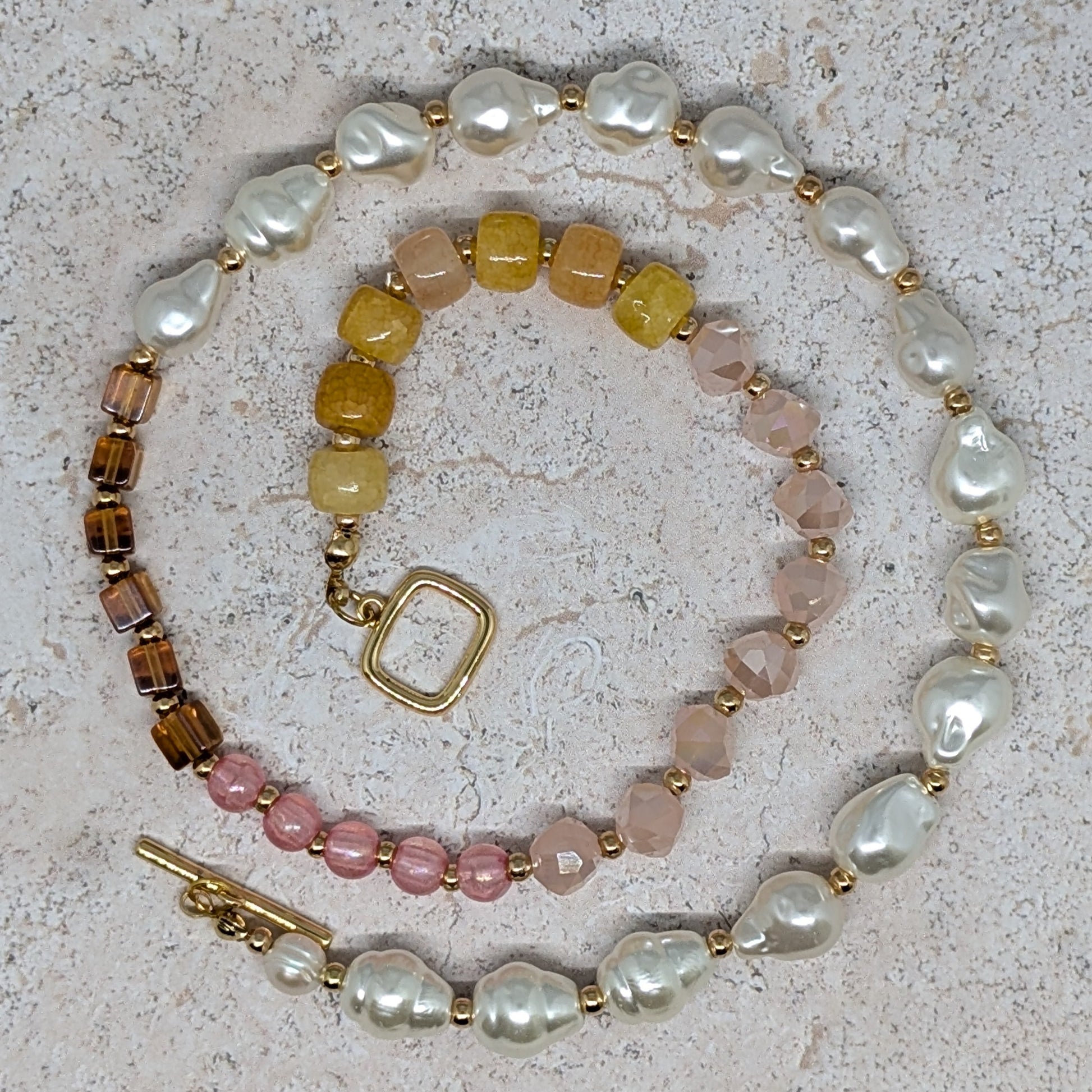 Set of beaded bracelets on a textured surface