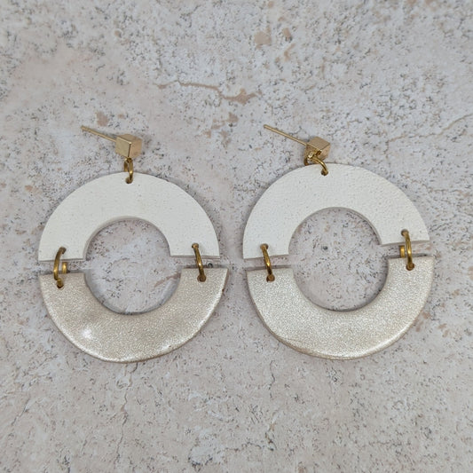 Pair of circular earrings on a textured surface