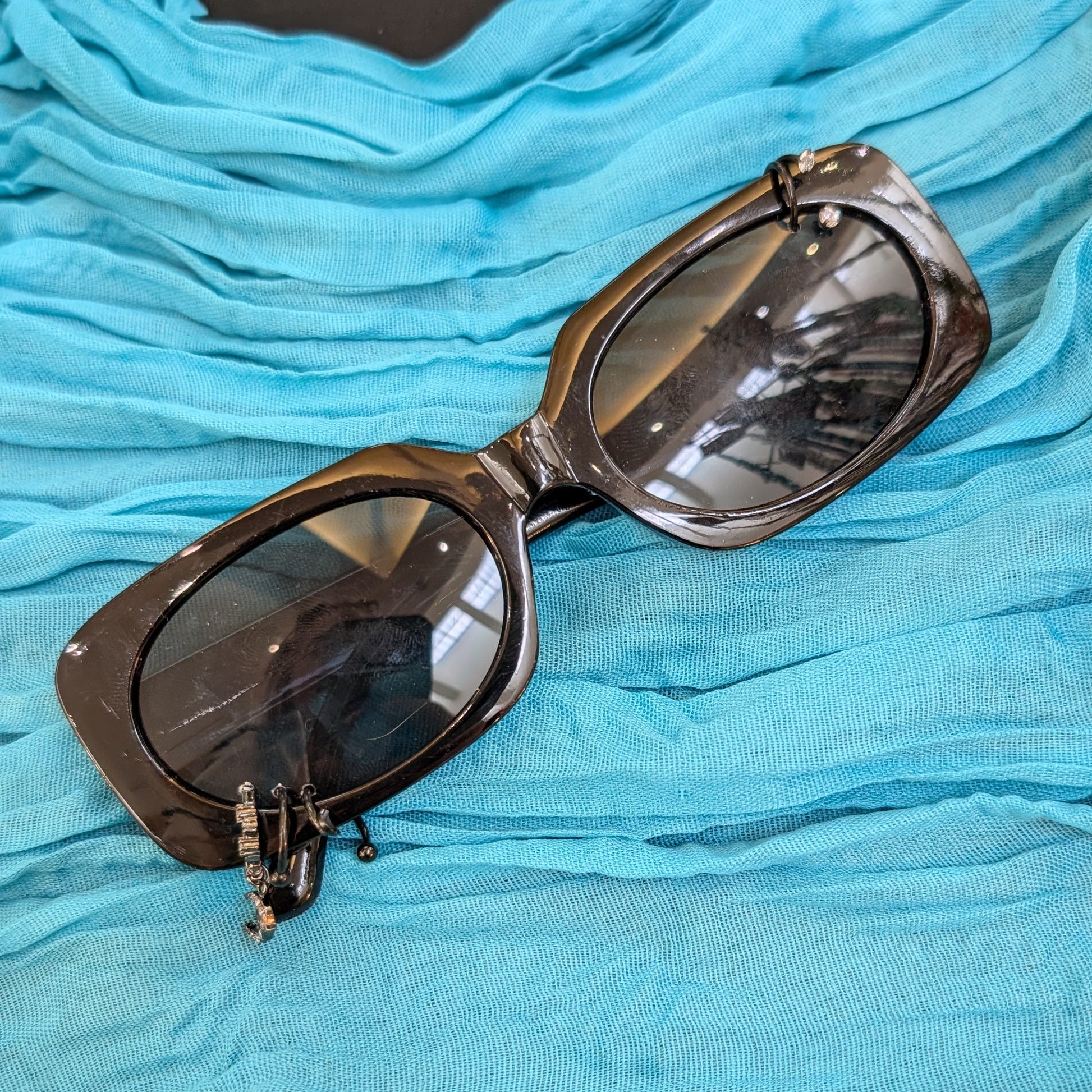Sunglasses on a blue fabric surface