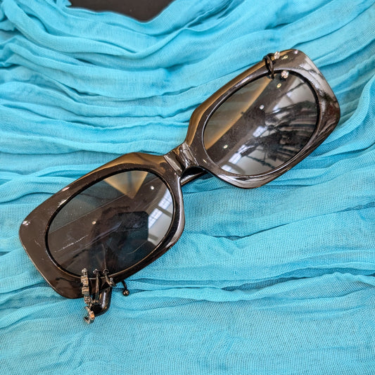 Sunglasses on a blue fabric surface