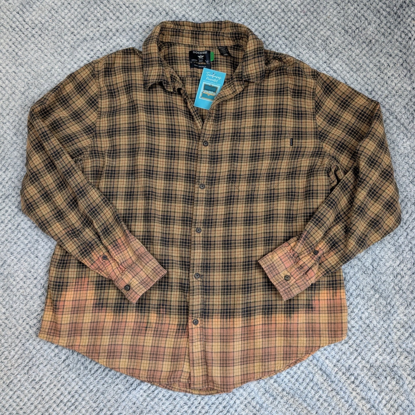 Plaid shirt with a tag on a textured gray background
