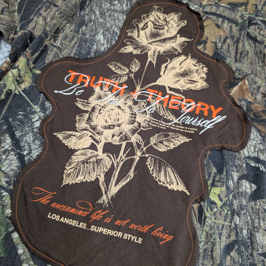 Patch with floral design and text on a camouflage background