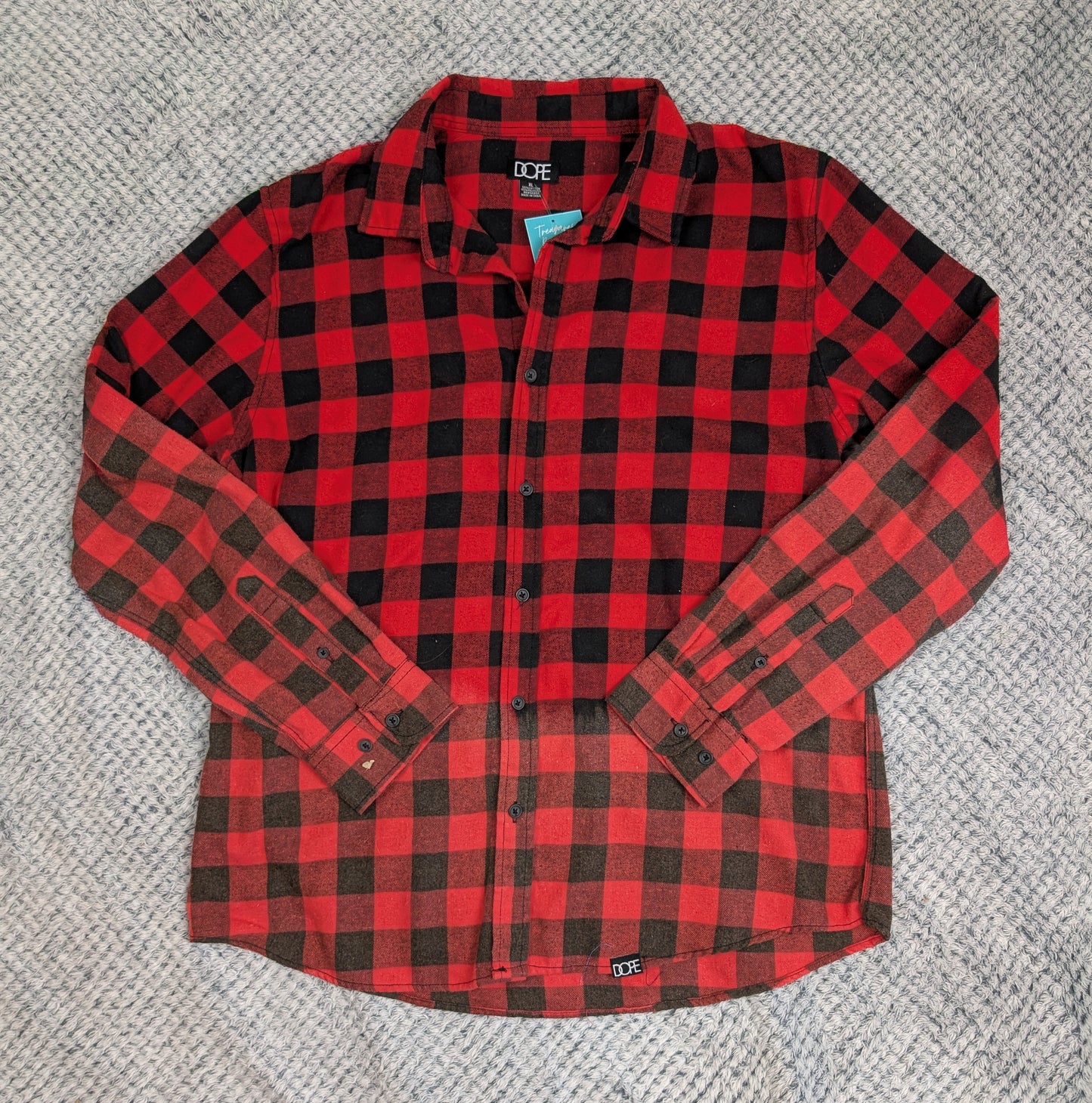 Red and black checkered shirt on a textured gray surface