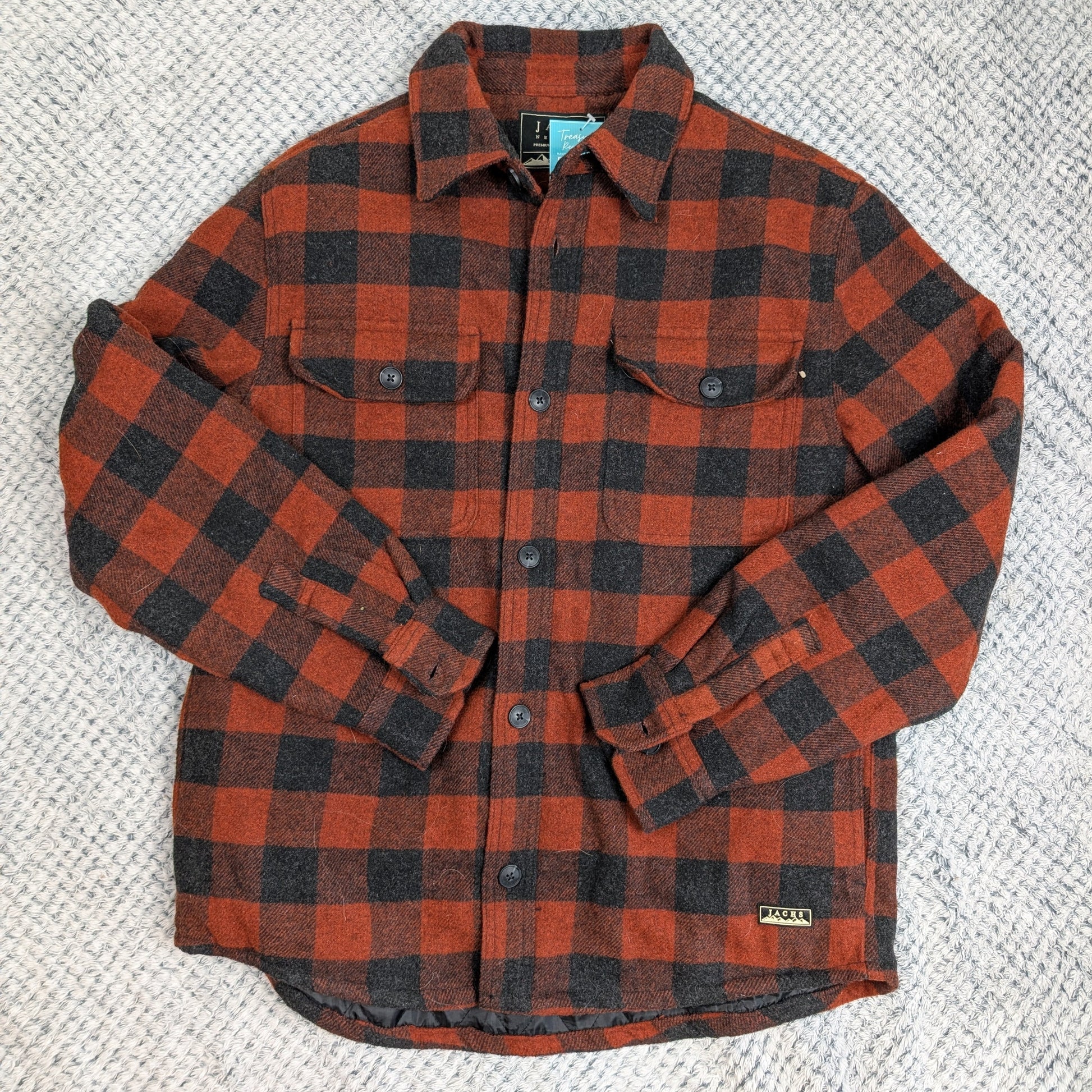 Red and black plaid shirt on a textured gray background